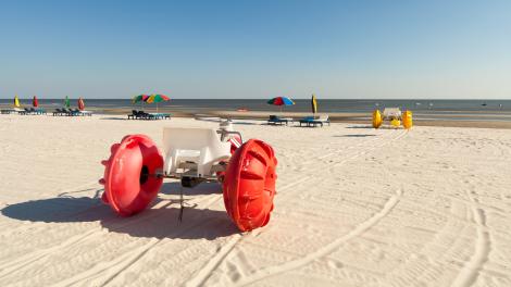 Colorful beach tricycles along the shoreline of Biloxi Beach