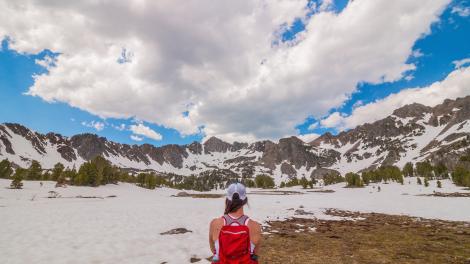 Hiking Beehive Basin surrounded by snow-capped peaks