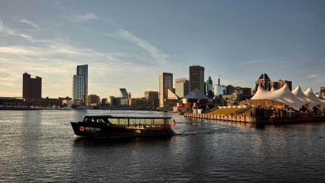 A water taxi glides across Baltimore’s Inner Harbor