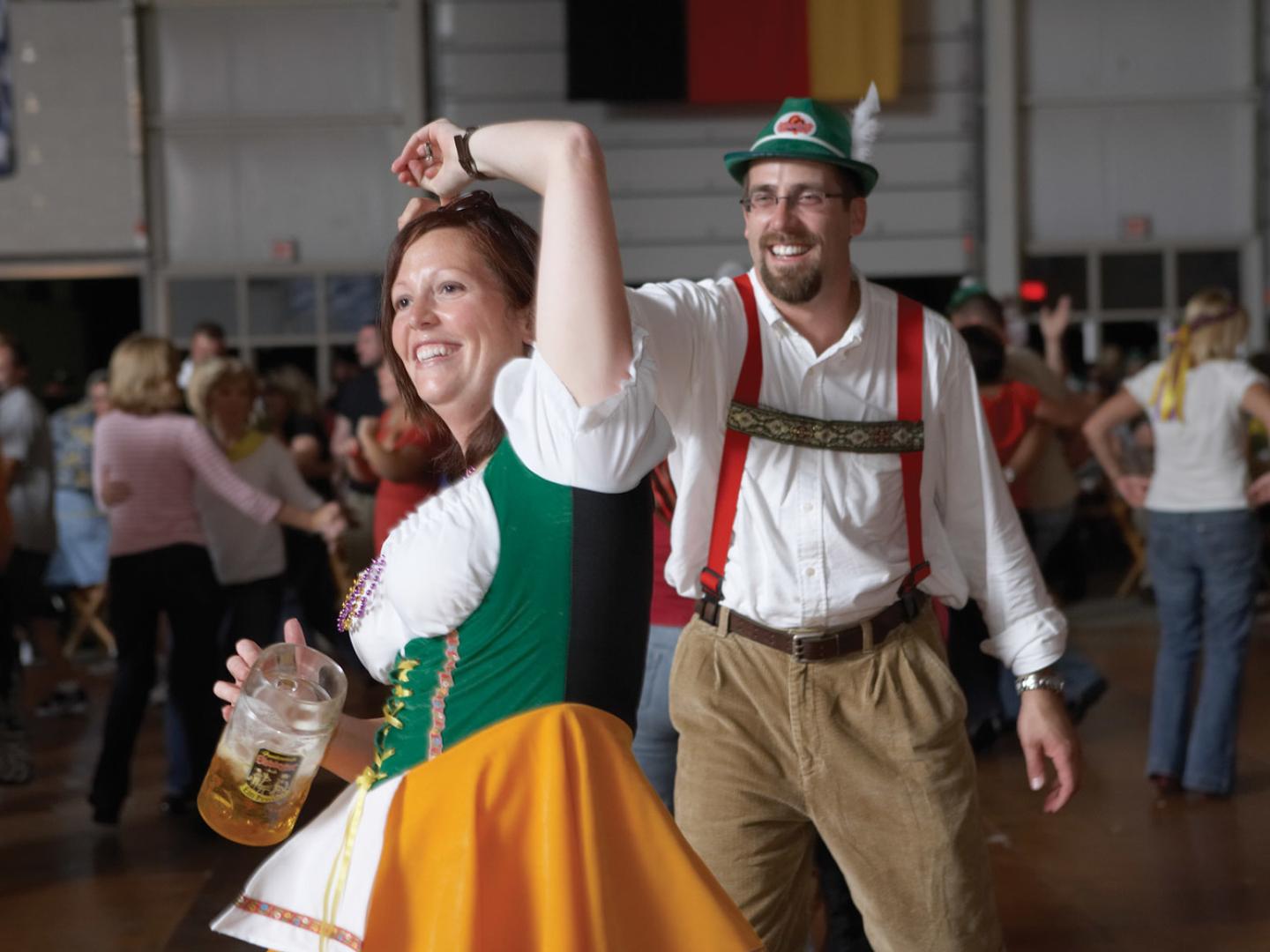 Dancing in traditional German outfits at Oktoberfest
