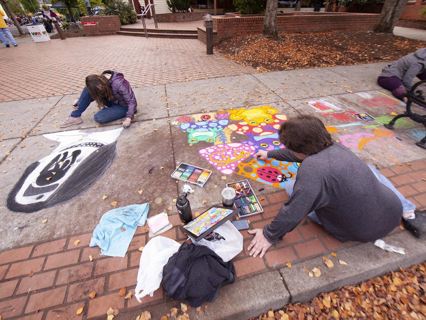 Artists at work during the Sidewalk Chalk Art Festival in Forest Grove, Oregon