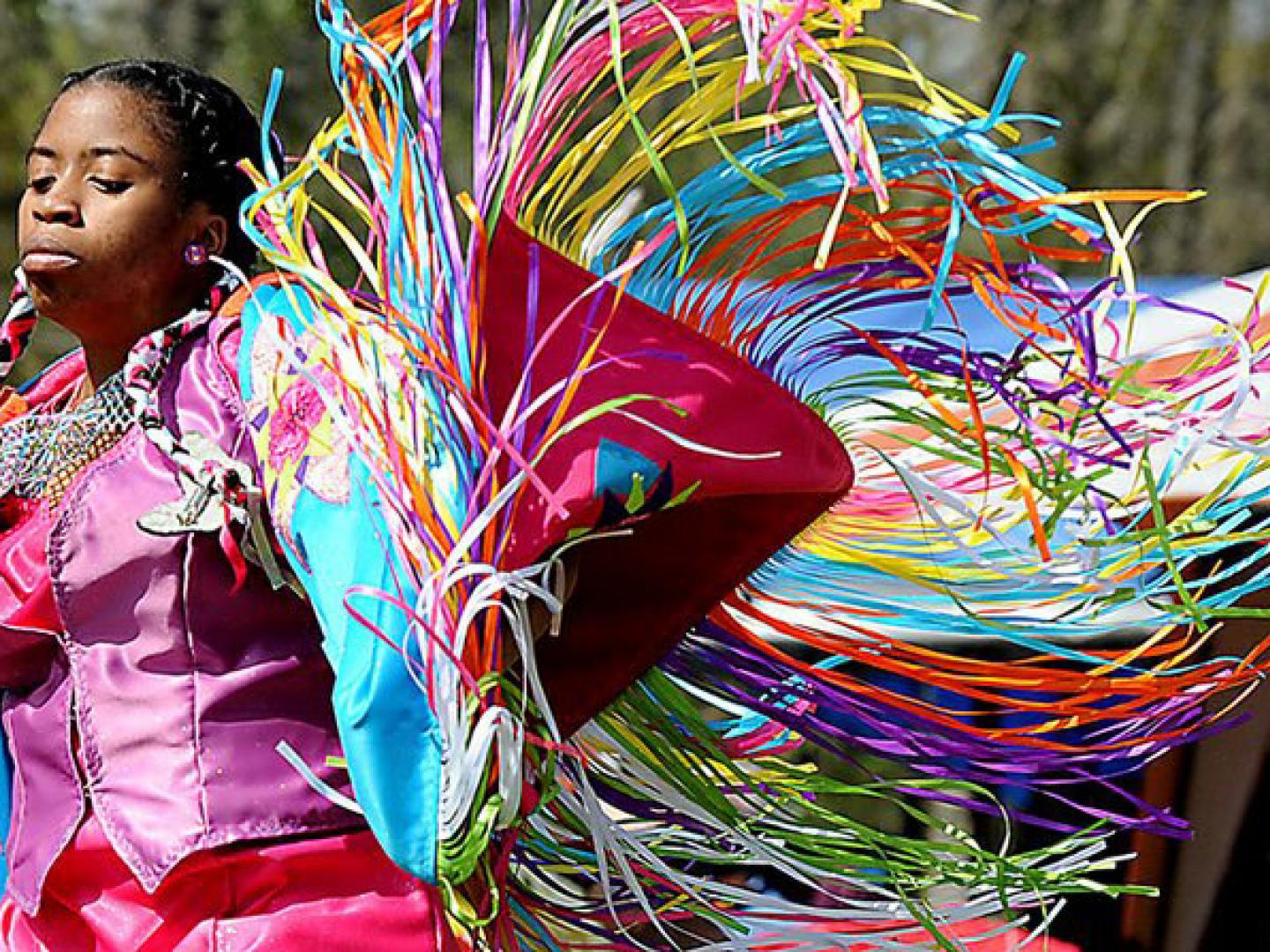 A woman dancing in tribal dress at the Grand Village of the Natchez Indians Powwow