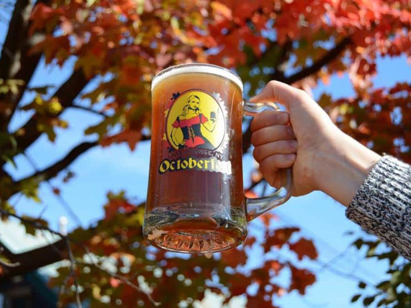 Raising a stein of beer during an Oktoberfest celebration in Lake George, New York