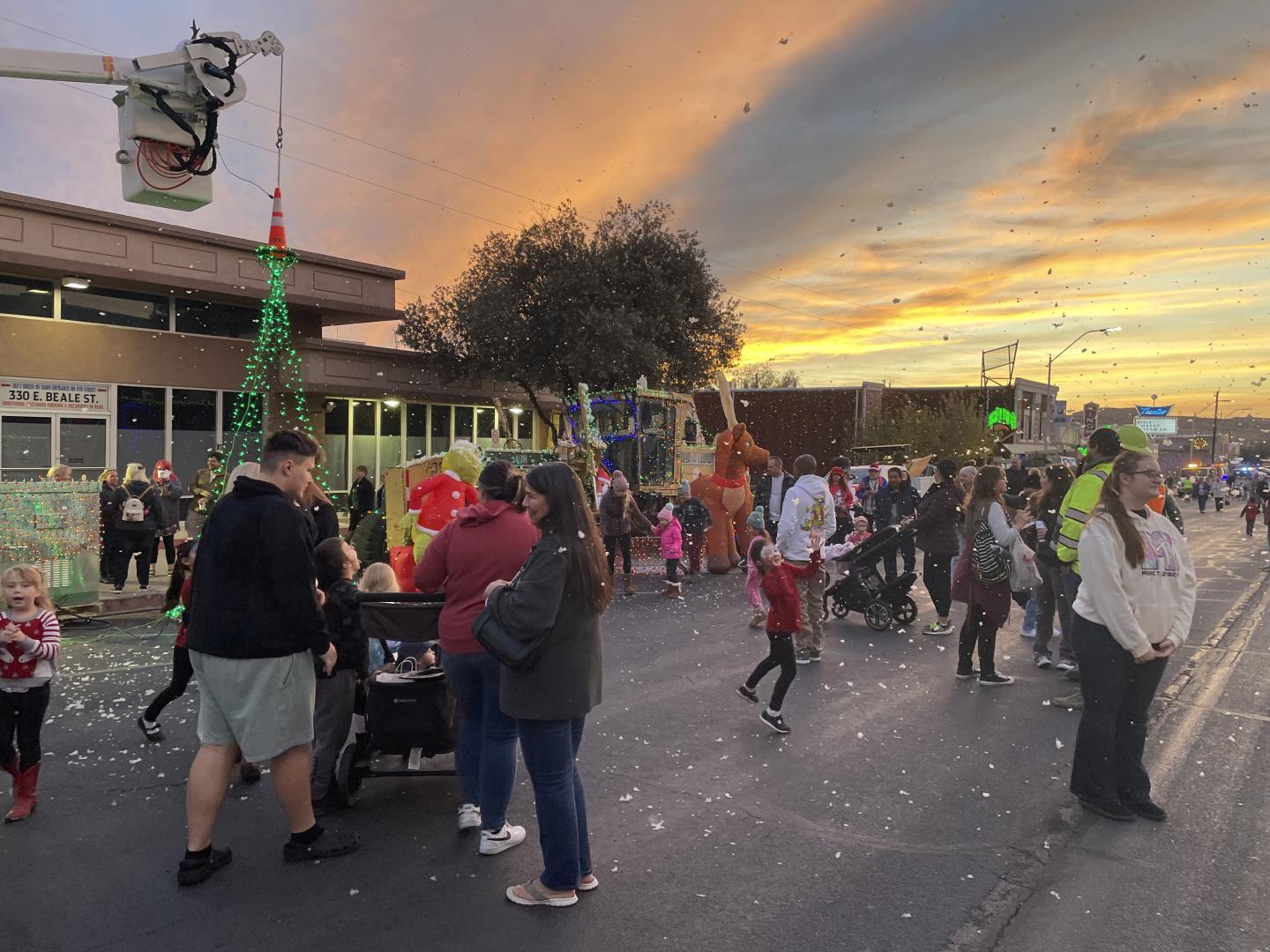 Visitors taking in the holiday lights and artificial snow at Very Merry Street of Lights in downtown Kingman, Arizona