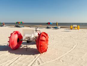 Colorful beach tricycles along the shoreline of Biloxi Beach Colorful beach tricycles along the shoreline of Biloxi Beach