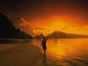 Rising sun over the mountains and coastline of the Manu'a Islands