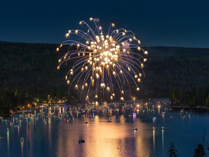Fireworks exploding over the picturesque Bass Lake for Independence Day