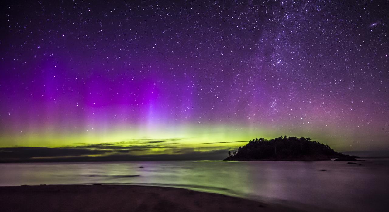 The aurora borealis, or northern lights, glowing over Little Presque Isle