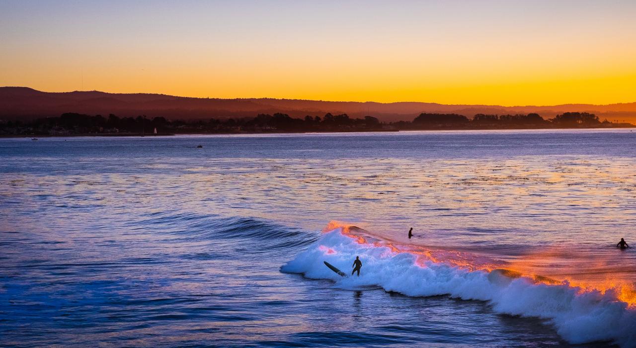 Setting sun casts a glow over the waves