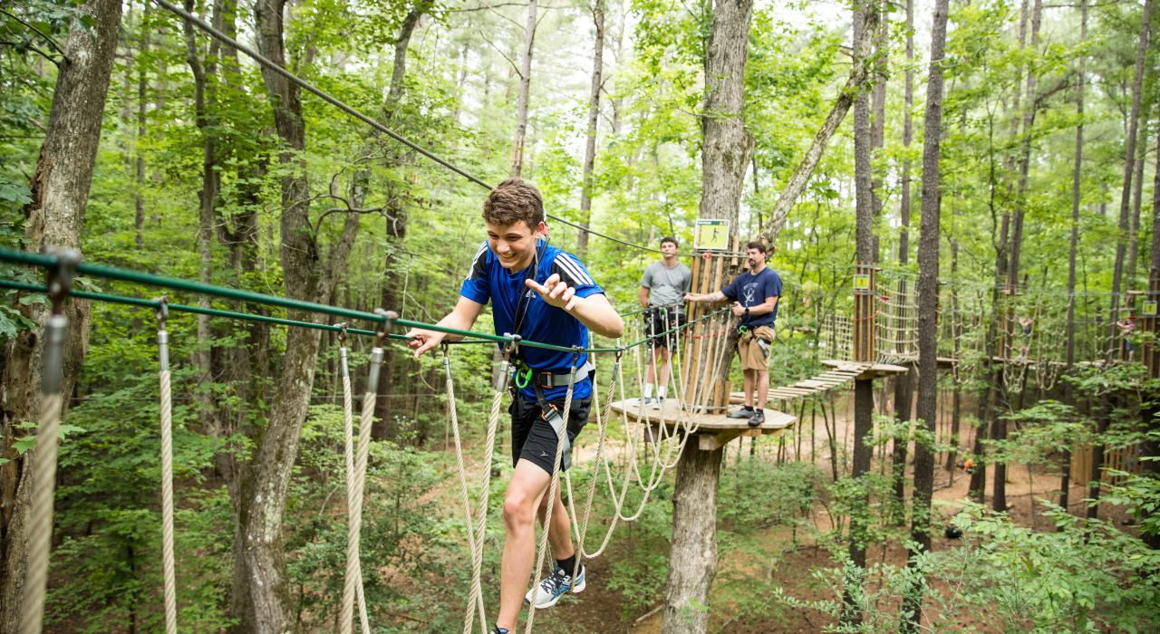 Tackling the rope bridge at Go Ape Zip Line & Treetop Adventure