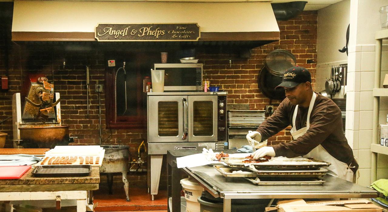 A chocolate maker at Angell & Phelps, where high-quality chocolates are made fresh by hand daily 