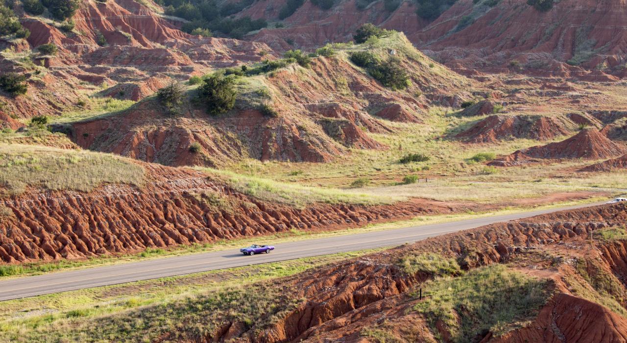 A classic car cruising through Gloss Mountain State Park in Fairview, Oklahoma A classic car cruising through Gloss Mountain State Park in Fairview, Oklahoma