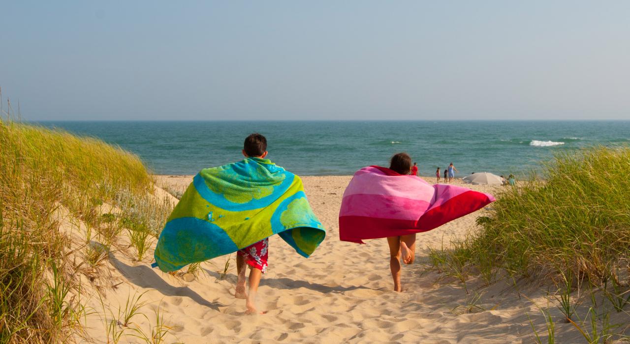 Children running through the soft sand on Katama Beach