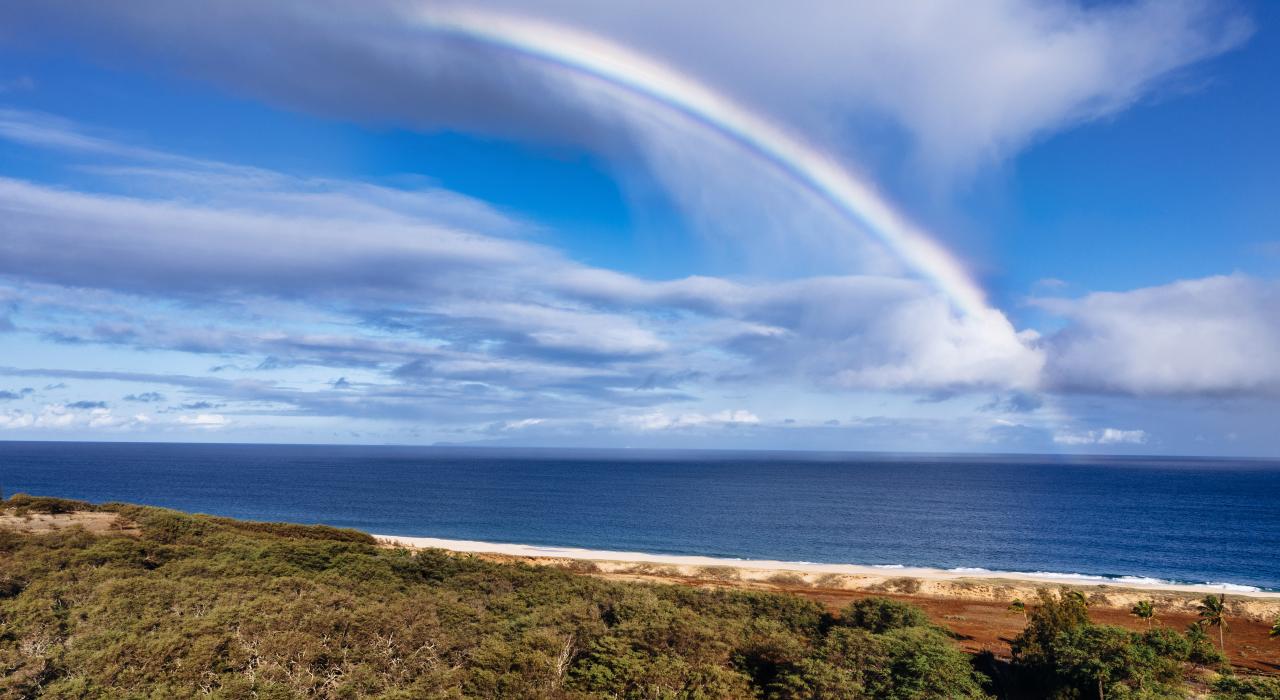 A rainbow stretches over Pāpōhaku Beach Park
