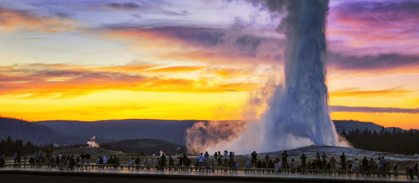 在日落时分，欣赏黄石国家公园内老忠实间歇泉的喷发